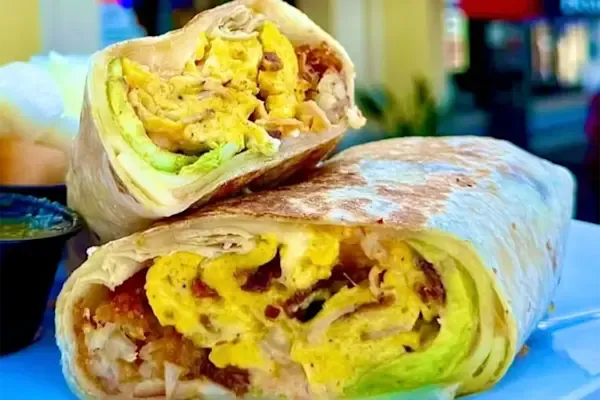 A bold mix of fluffy scrambled eggs, crispy thick-cut bacon, American yellow cheddar cheese, spicy jalapeños, freshly sliced avocado, smoky chipotle sauce, crispy hash browns, and a hint of maple syrup, all wrapped in a warm flour tortilla. 