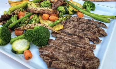 Grilled filet mignon, Includes choice of 2 veggie sides, broccoli, portobello mushroom, zucchini, or carrots with your choice of soup or house salad.