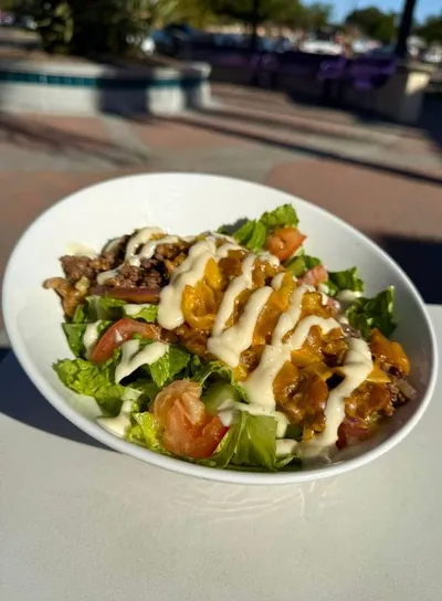 Chopped rib eye steak, grilled onions, grilled banana peppers, shredded romaine lettuce, chopped Roma tomatoes, garlic aioli, and vermont cheddar cheese with your choice of with your choice of soup or house salad